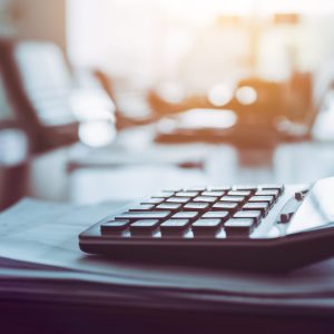 Close Up Calculator On Business Working Desk, Dark Background.